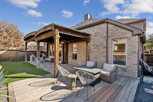 wooden deck featuring an outdoor living space, a patio area, and a yard