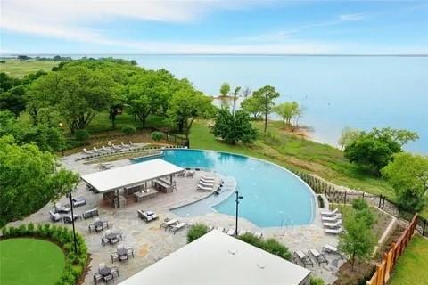 view of pool featuring a water view and a patio