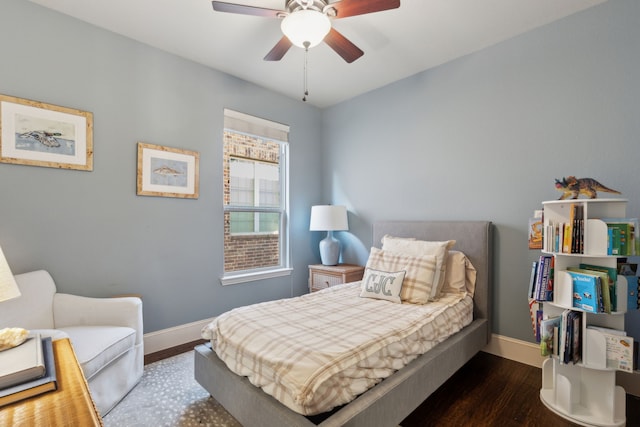 bedroom with ceiling fan and dark hardwood / wood-style floors