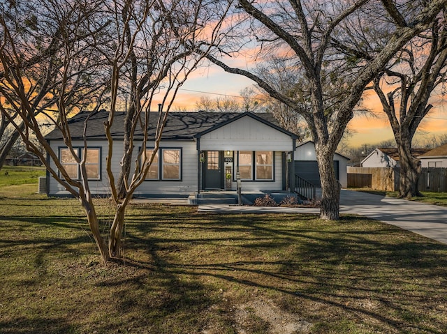 ranch-style home with a yard