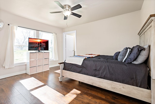 bedroom featuring dark wood-type flooring, ceiling fan, and multiple windows