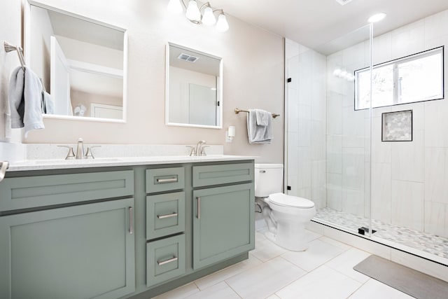 bathroom with toilet, vanity, tile patterned flooring, and a shower with shower door