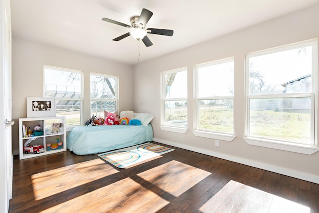 bedroom with ceiling fan and dark hardwood / wood-style floors