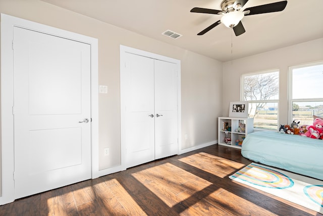 bedroom with ceiling fan and dark wood-type flooring