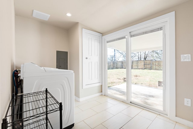 washroom featuring electric panel, washer / dryer, and light tile patterned floors