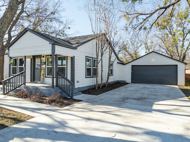 view of front of home featuring covered porch, a garage, and an outdoor structure