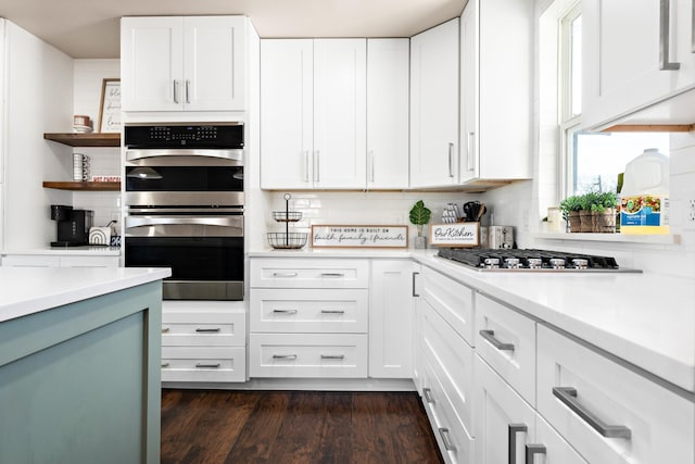 kitchen featuring dark hardwood / wood-style flooring, white cabinets, and appliances with stainless steel finishes