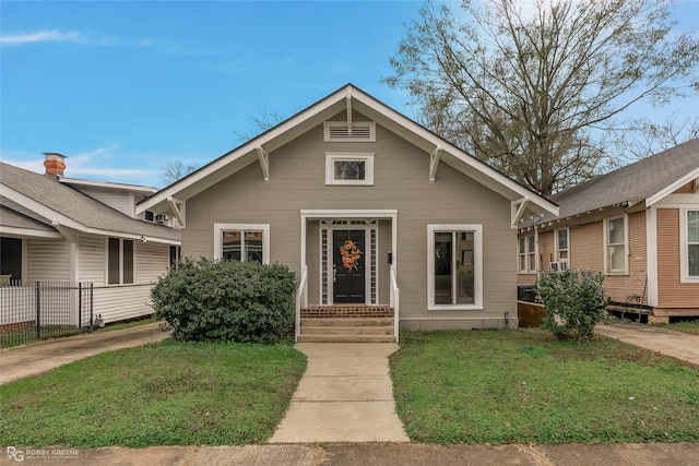 bungalow-style home featuring a front lawn