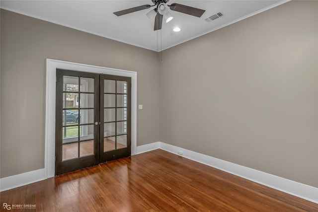 unfurnished room featuring dark wood-type flooring, ceiling fan, french doors, and ornamental molding