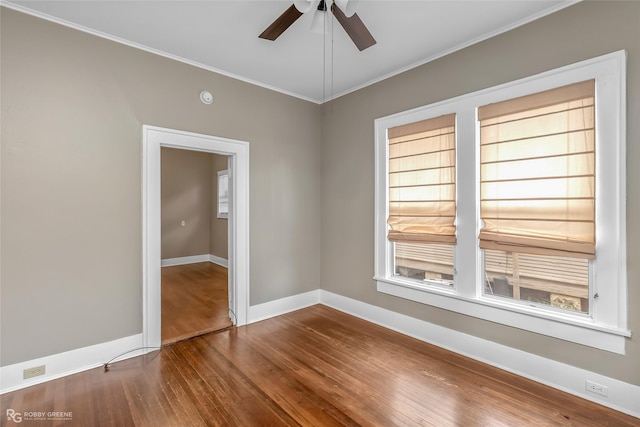 spare room with ceiling fan, hardwood / wood-style flooring, and crown molding