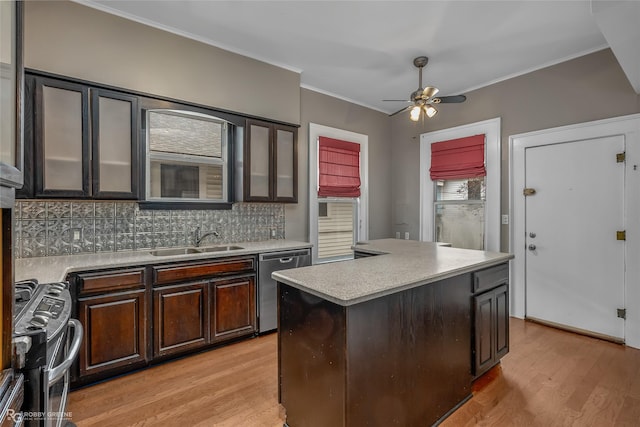 kitchen featuring a center island, tasteful backsplash, appliances with stainless steel finishes, dark brown cabinets, and sink