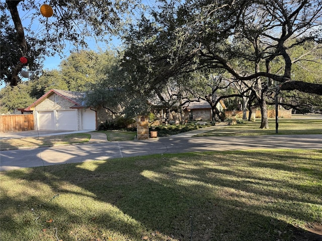 view of front of home featuring a garage, a front yard, and an outbuilding