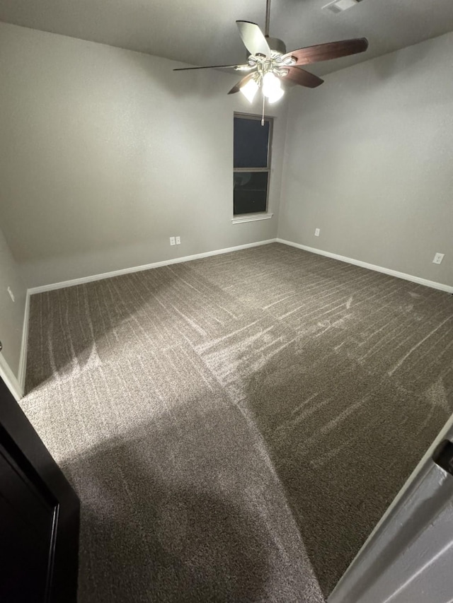 empty room featuring ceiling fan and carpet flooring