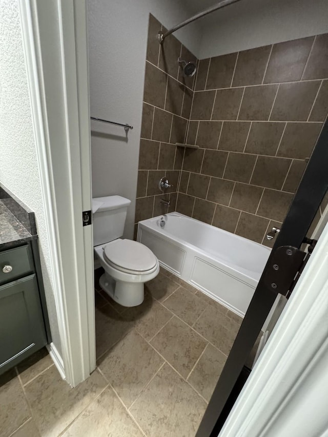 full bathroom featuring toilet, tiled shower / bath combo, and vanity