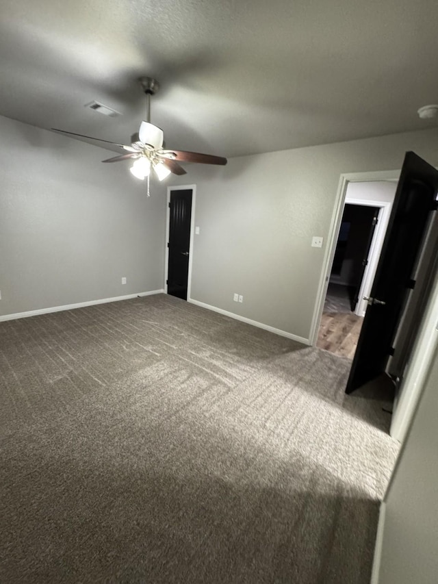 interior space featuring carpet floors and ceiling fan