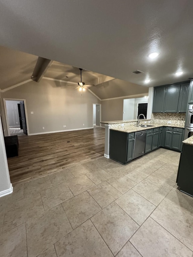 kitchen featuring dishwasher, vaulted ceiling with beams, ceiling fan, sink, and backsplash