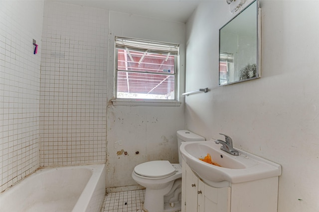 bathroom featuring toilet, vanity, tile patterned floors, and a tub