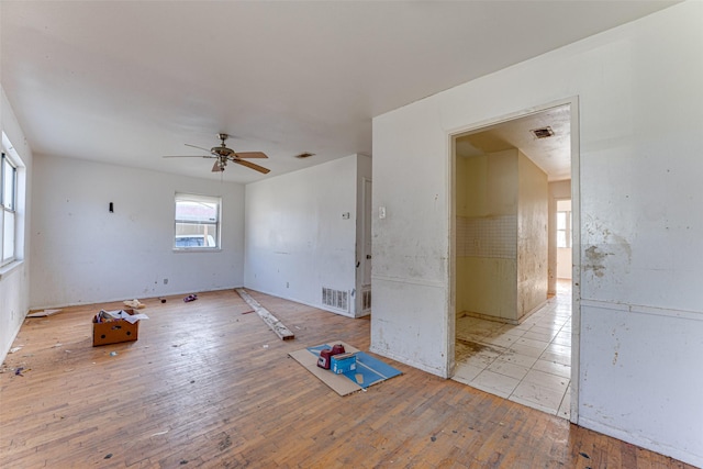 empty room featuring ceiling fan and light hardwood / wood-style flooring