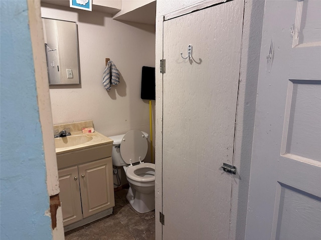 bathroom featuring toilet and vanity