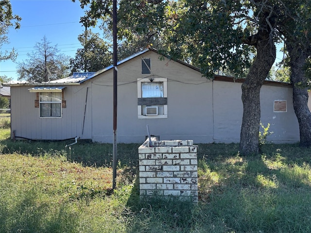 view of side of property with a yard