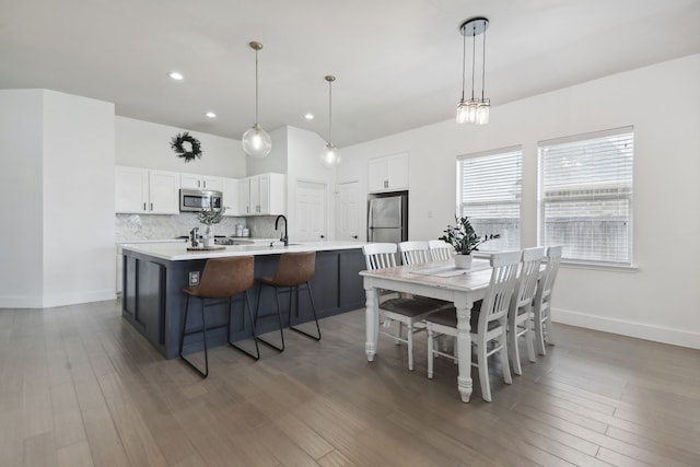 dining area with sink and dark wood-type flooring