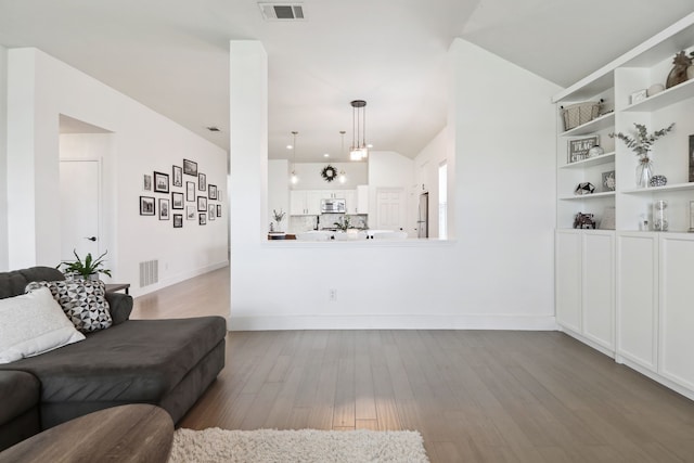 living room with lofted ceiling and light hardwood / wood-style flooring