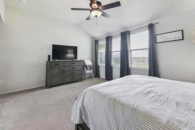 bedroom with light carpet, ceiling fan, and vaulted ceiling