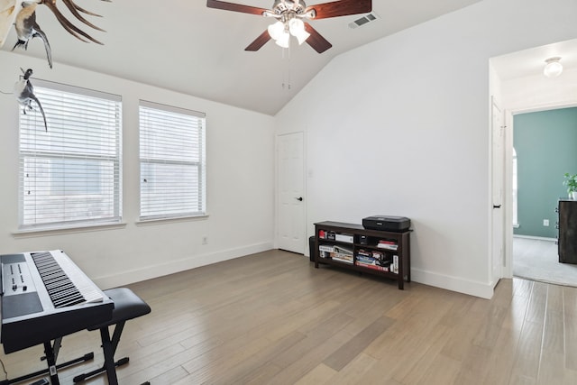 misc room with vaulted ceiling, light wood-type flooring, a wealth of natural light, and ceiling fan