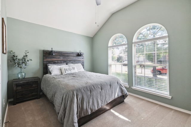 carpeted bedroom featuring ceiling fan and vaulted ceiling