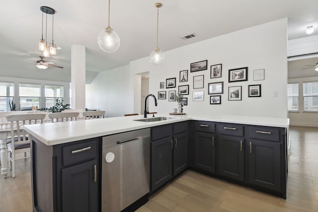 kitchen featuring light hardwood / wood-style floors, hanging light fixtures, ceiling fan, sink, and stainless steel dishwasher