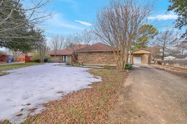 single story home with a garage and an outdoor structure