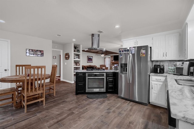 kitchen featuring island exhaust hood, stainless steel appliances, dark hardwood / wood-style flooring, decorative backsplash, and white cabinets