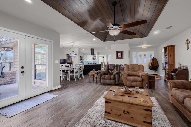 living room featuring ceiling fan, french doors, wood ceiling, and dark hardwood / wood-style floors