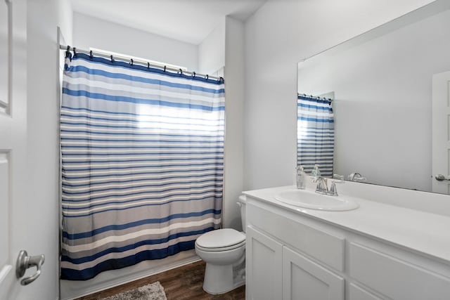 bathroom featuring toilet, a shower with shower curtain, wood-type flooring, and vanity