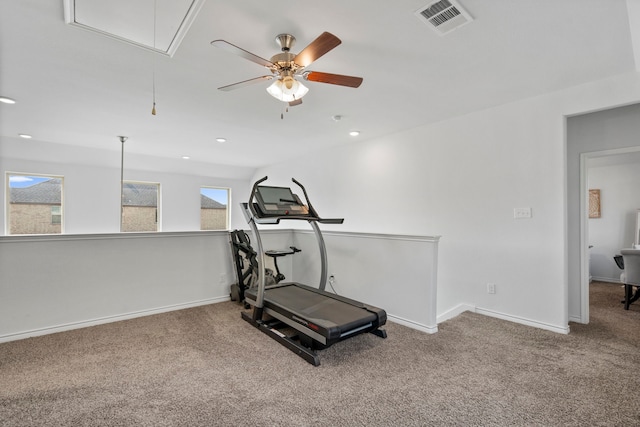 exercise room with ceiling fan and carpet