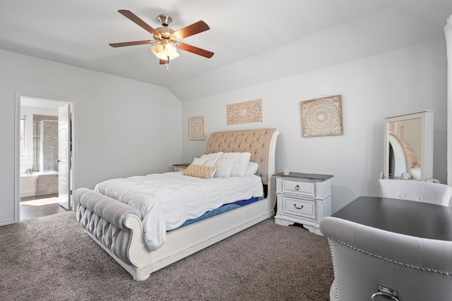 bedroom featuring ensuite bathroom, ceiling fan, vaulted ceiling, and dark colored carpet