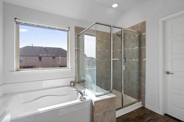 bathroom featuring vaulted ceiling, plus walk in shower, and wood-type flooring