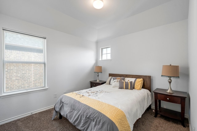 bedroom with dark colored carpet