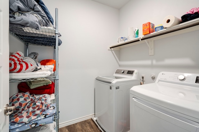 laundry room with washer and dryer and dark hardwood / wood-style flooring