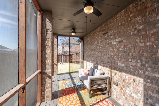 unfurnished sunroom with ceiling fan and plenty of natural light