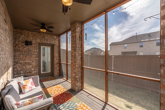 sunroom / solarium featuring ceiling fan