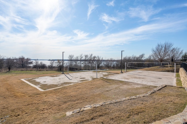 view of home's community featuring volleyball court and a yard