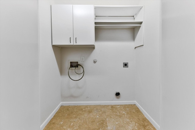 washroom with gas dryer hookup, washer hookup, electric dryer hookup, and cabinets