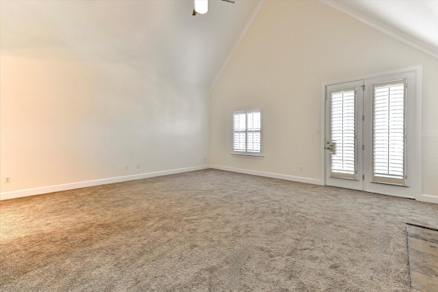 unfurnished living room with high vaulted ceiling, ceiling fan, and carpet