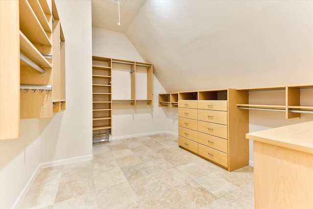 walk in closet with lofted ceiling