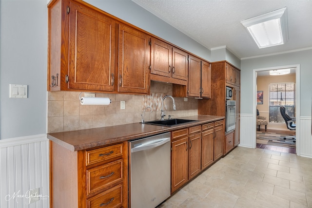 kitchen with stainless steel appliances, a textured ceiling, light tile patterned flooring, and sink