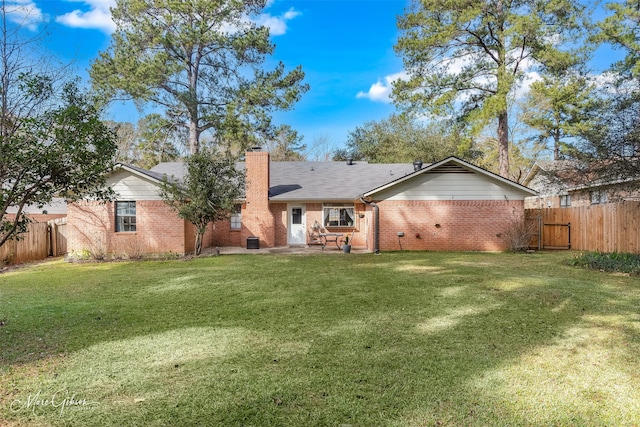 back of property with a patio and a lawn