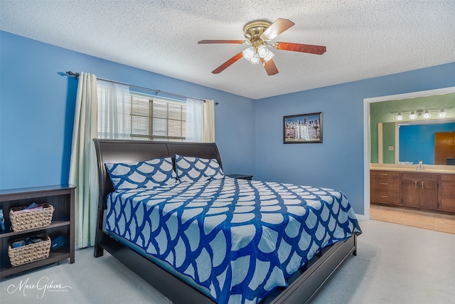 carpeted bedroom with sink, ensuite bathroom, a textured ceiling, and ceiling fan