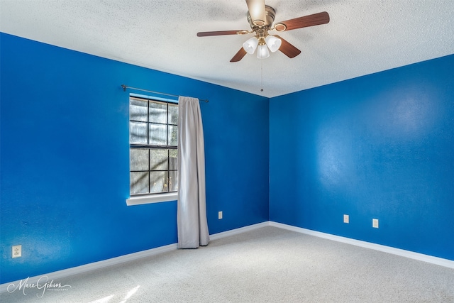 unfurnished room with a textured ceiling, carpet floors, and ceiling fan