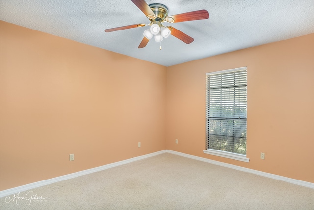 carpeted empty room featuring a textured ceiling and ceiling fan